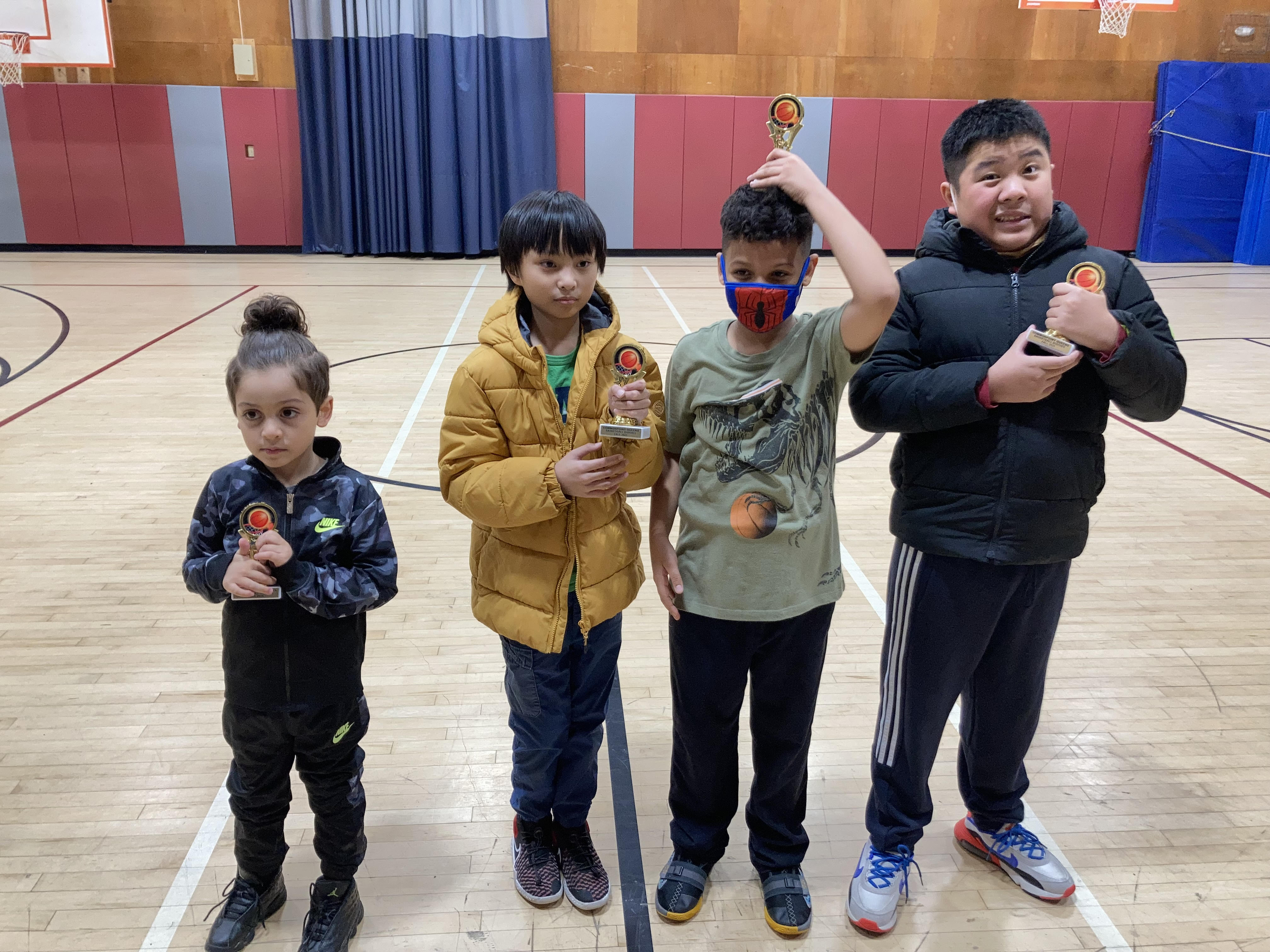 A group of children with developmental disabilities standing in a gymnasium participating in programs.