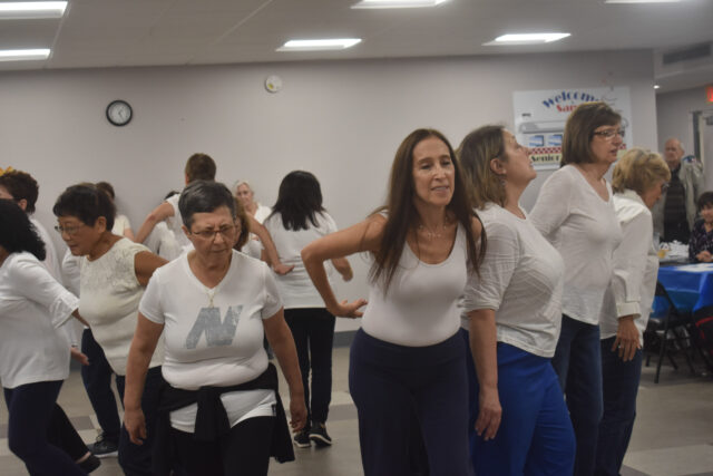 A group of women are dancing in a room.