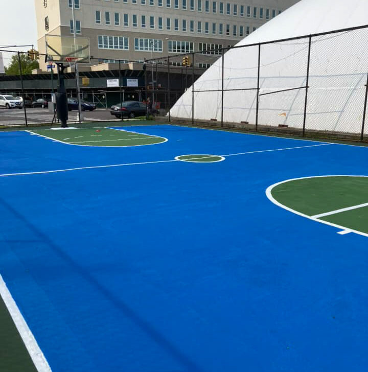 A basketball court with blue and white paint on it.
