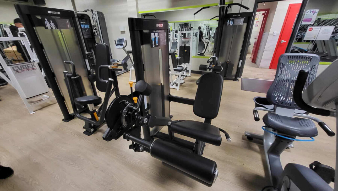 A gym with a lot of equipment in it.