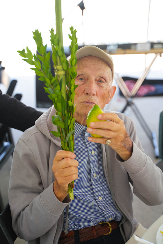 A man is eating a green leaf.