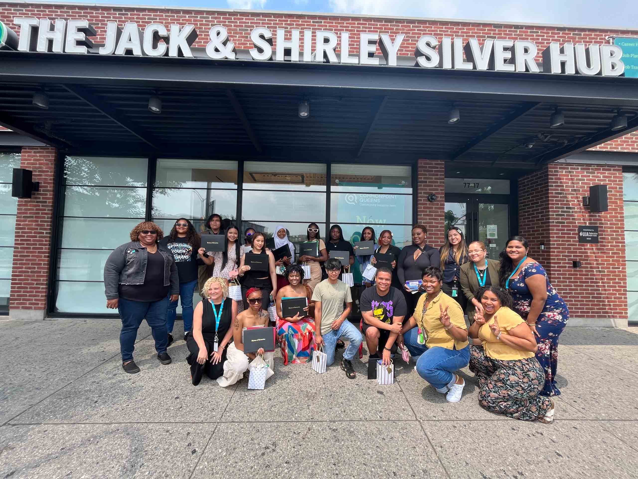 A group of women posing in front of the jack & shirley silver hub.
