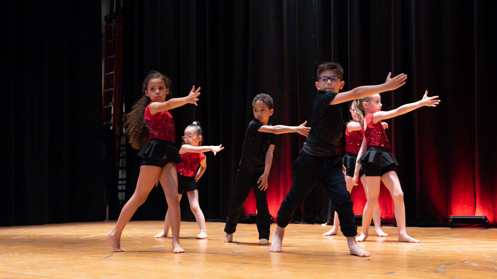A group of young dancers on a stage.