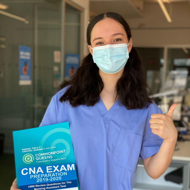 A nurse holding up a CNA exam book, providing an overview of workforce services.