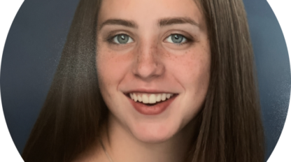 A portrait of Alexis Shapiro, a young woman with brown hair and blue eyes.